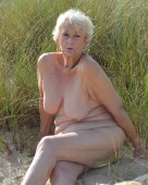 Curvy granny Sparkle shows off her naked body on the beach