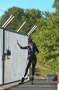 Catsuit By The Gate featuring Hot Milf