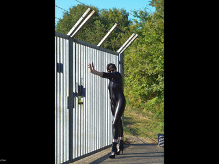 Hot Milf - Catsuit By The Gate